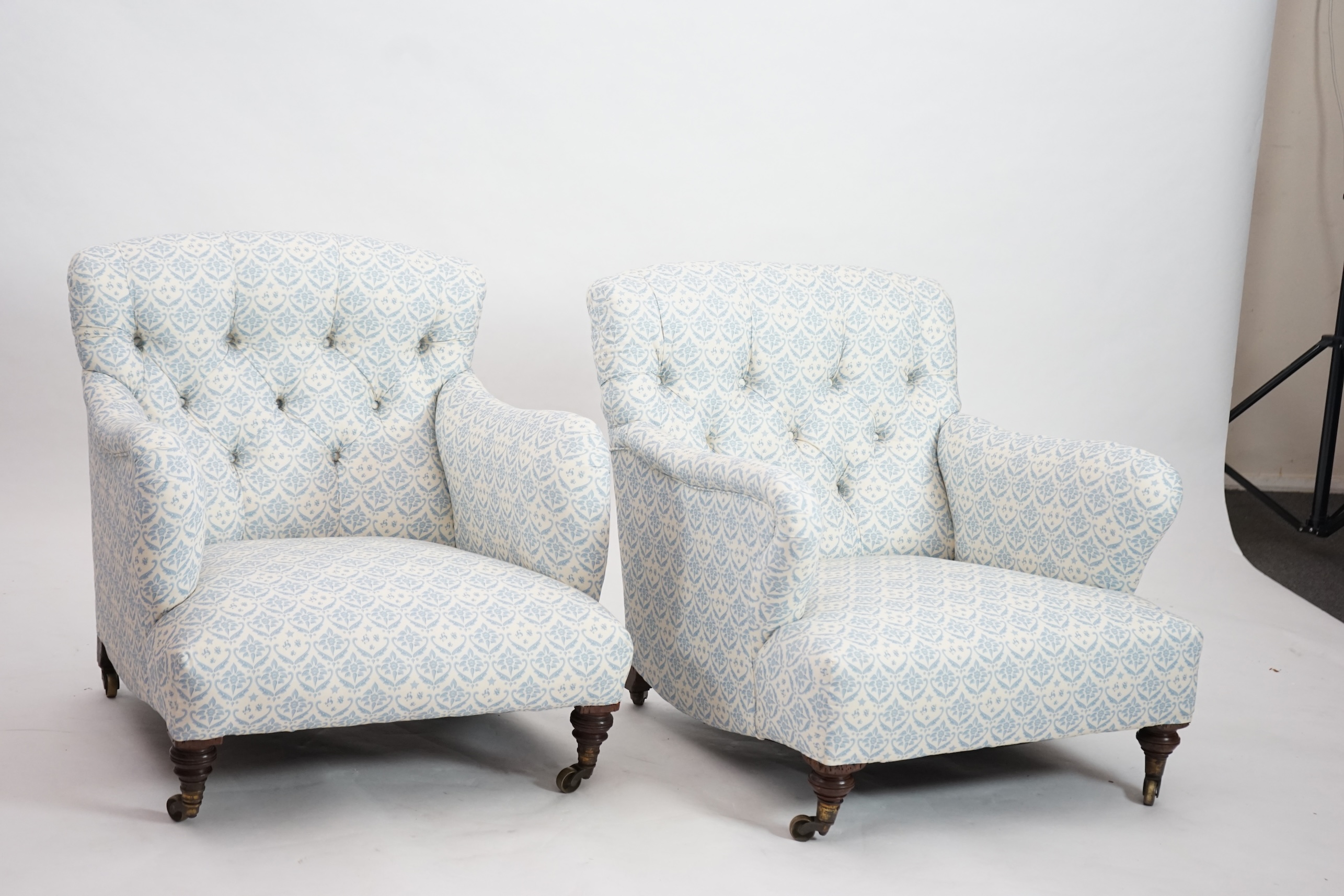 A Victorian Howard & Sons Bridgewater armchair and a similar Victorian armchair